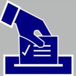 Hand putting ballot into ballot box