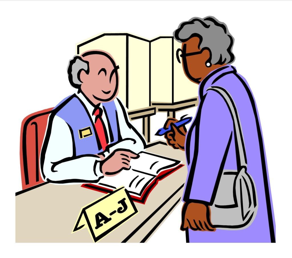 Election worker sitting at table, showing voter where to sign in